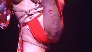 Marvelous Japanese Chick In Bondage Entertains A Crowd Of People In This Live On Stage Scene
